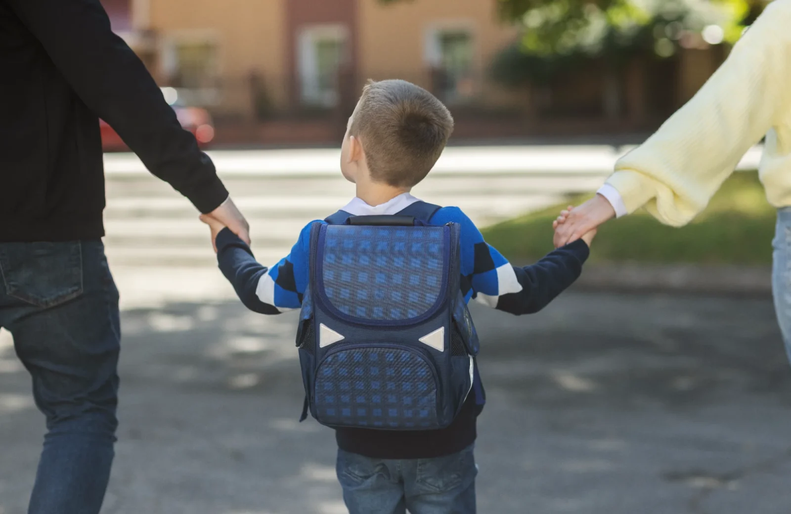 Child walking to school with family support
