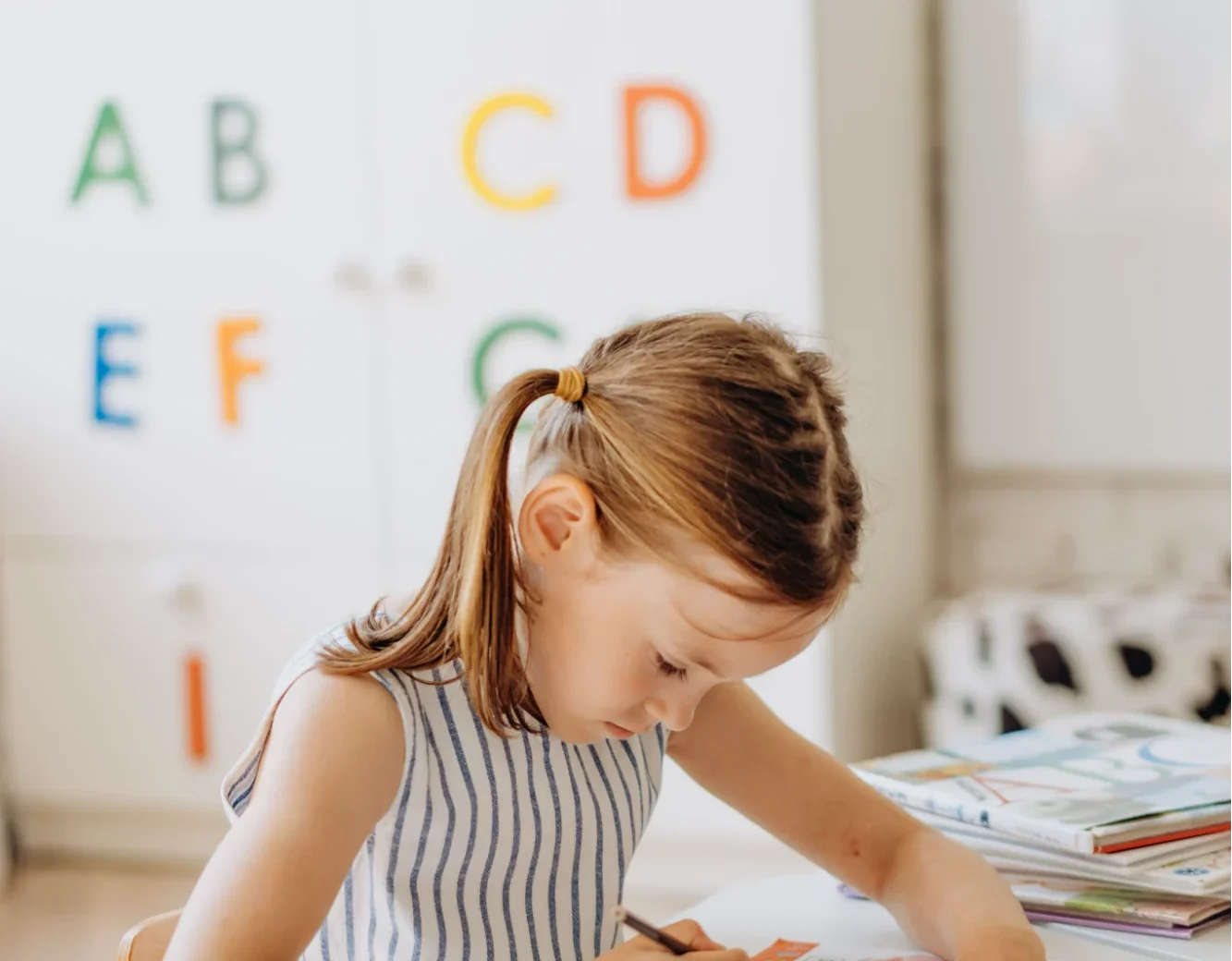 Young child drawing in an early learning environment