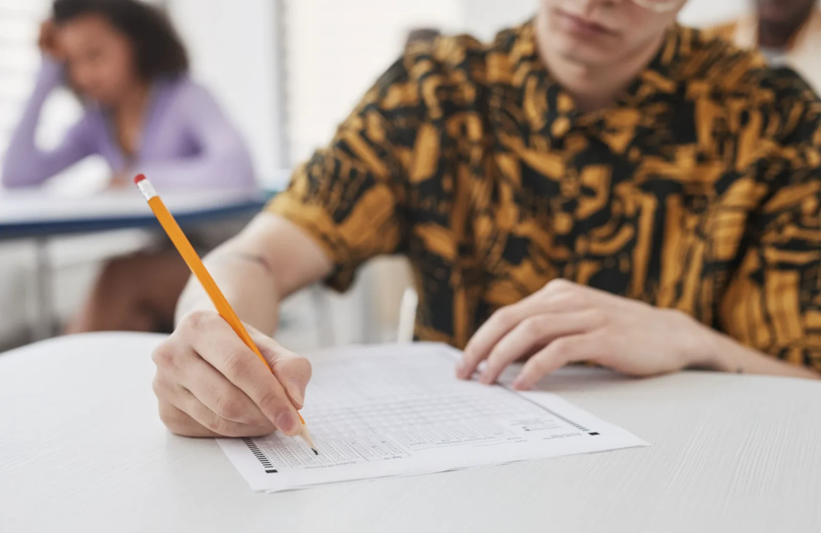 Student completing an exam paper